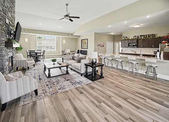 A clubhouse with a fireplace and a dining table at Trade Winds Apartment Homes, Elkhorn, NE, 68022