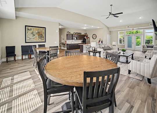 A dining room with a wooden table and chairs at Trade Winds Apartment Homes, Elkhorn, NE, 68022