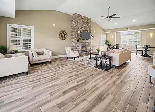 A community room with a stone fireplace and a flat screen TV at Trade Winds Apartment Homes, Elkhorn, NE, 68022