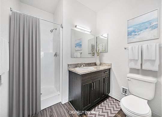 A second bathroom with a sink, toilet, and shower at Trade Winds Apartment Homes, Elkhorn, Nebraska