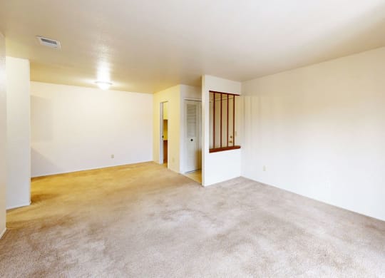 Seville style living room with carpet at Trappers Cove Apartments, Michigan