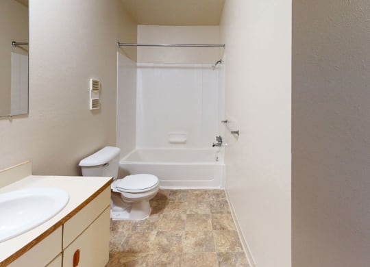 a bathroom with a sink toilet and a shower  at Trappers Cove Apartments, Lansing, MI