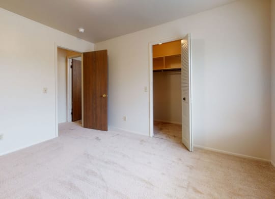 bedroom with a door to a closet  at Trappers Cove Apartments, Michigan