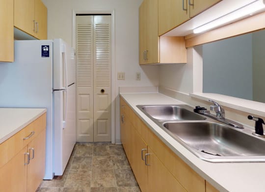 a kitchen with a pantry at Trappers Cove Apartments, Lansing, MI