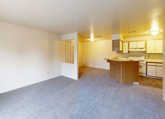 the living room and dining room with breakfast bar  at Trappers Cove Apartments, Lansing, MI