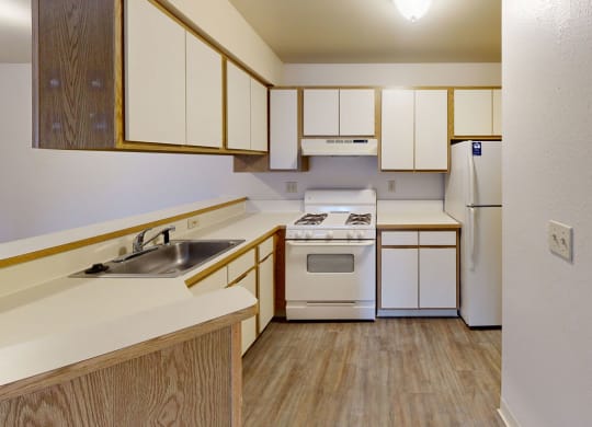 large kitchen with white appliances  at Trappers Cove Apartments, Lansing
