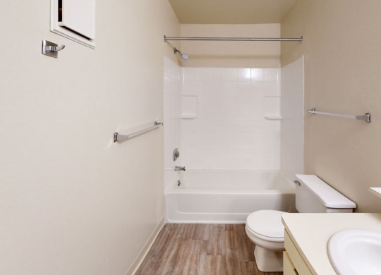 a bathroom with a sink toilet and a shower  at Trappers Cove Apartments, Michigan, 48910