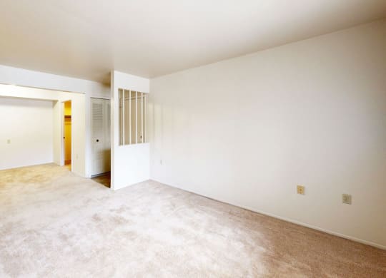 living room and dining room with carpeting  at Trappers Cove Apartments, Michigan