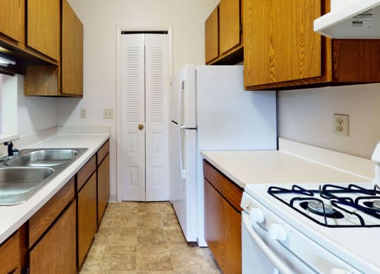 a kitchen with a pantry at Trappers Cove Apartments, Lansing, 48910