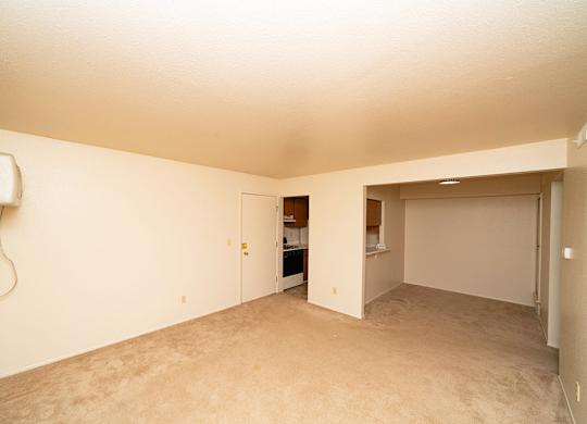 Empty dining room with a breakfast bar and plush carpet at Trappers Cove Apartments, Lansing