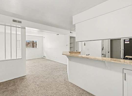 A white dining room with a breakfast bar at Trappers Cove Apartments, Lansing