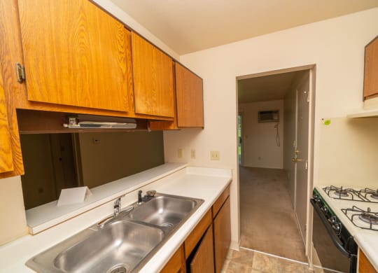 Kitchen leads to Living and Dining Areas at Trappers Cove Apartments, Lansing, MI, 48910