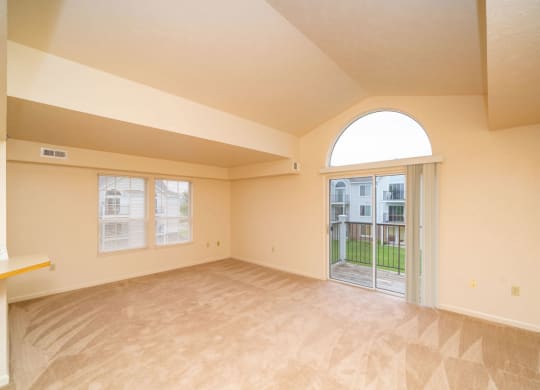 enlarged living room with a door to a patio at Trillium Pointe Apartment Homes, Jackson, MI, 49201