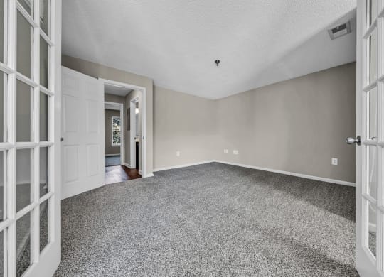 the living room of an empty house with white doors at Trophy Club at Bellgrade, Midlothian, VA, 23113