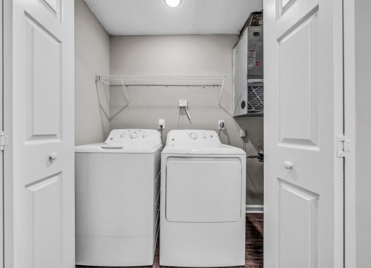 a washer and dryer in a laundry room with white appliances at Trophy Club at Bellgrade, Midlothian, VA, 23113