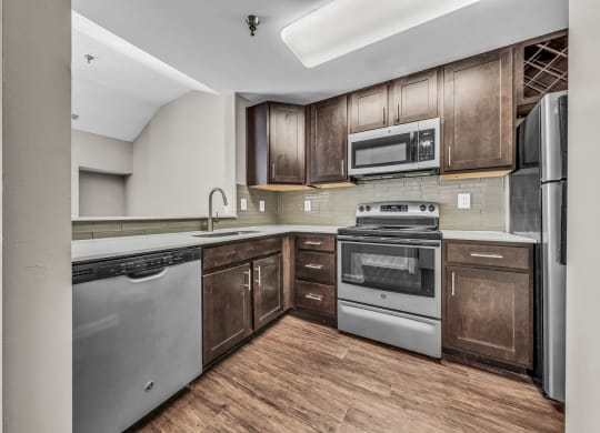 a kitchen with stainless steel appliances and wooden cabinets at Trophy Club at Bellgrade, Midlothian, VA, 23113