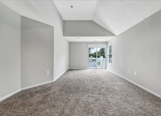 an empty living room with a door to a balcony at Trophy Club at Bellgrade, Midlothian, VA, 23113