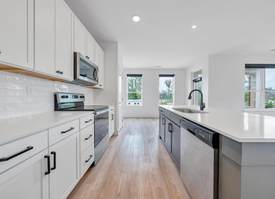 a kitchen with white cabinets and white countertops at Luxe 360 in Midlothian, Midlothian, 23114