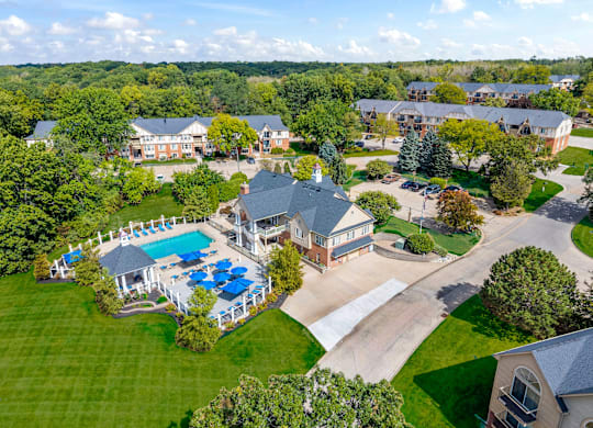 A large house with a pool surrounded by trees at Timberlane Apartments, Illinois, 61615