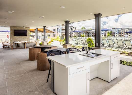 Open clubhouse kitchen with sitting are and TV at Upper Vue Flats, Dublin, OH, Ohio