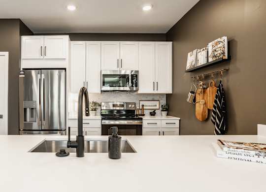 A modern kitchen with a white countertop and stainless steel appliances at Upper Vue Flats, Dublin