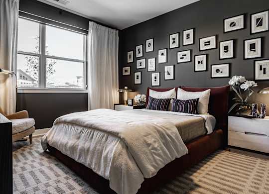 A bedroom with a large bed, a nightstand, and a window at Upper Vue Flats, Dublin