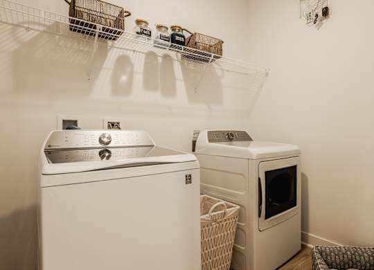 A white washing machine and dryer in a laundry room at Upper Vue Flats, Dublin