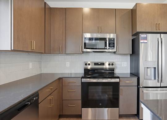 A kitchen with a stove, refrigerator, and microwave at Upper Vue Flats, Dublin