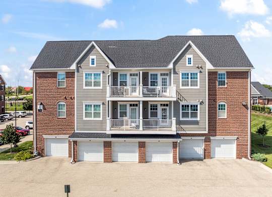 A large two-story house with a garage on the ground floor