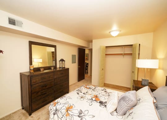 Carpeted Bedroom With Large Closet at Walnut Trail Apartments, Michigan