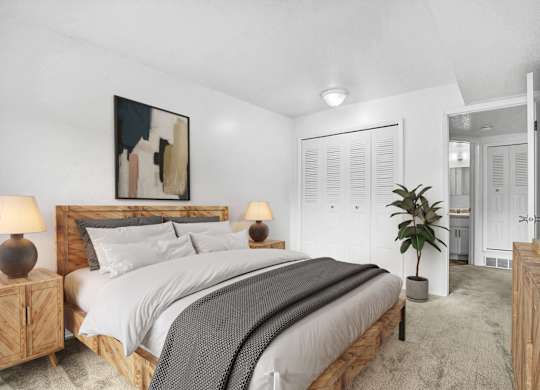 A bedroom with a large bed and closet at Walnut Trail Apartments, Portage, MI, 49002