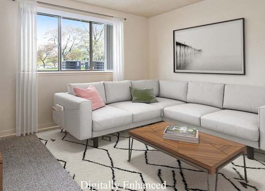A garden style living room with a grey couch, a wooden coffee table, and a large window with curtains at Walnut Trail Apartments, Portage, MI, 49002