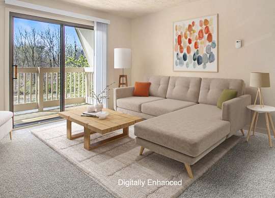 A living room with a couch, a coffee table, and a slider to a balcony at Walnut Trail Apartments, Portage, MI, 49002