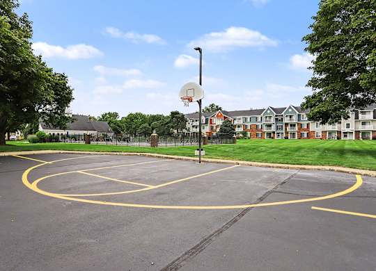 A basketball court with a hoop at Walnut Trail Apartments, Michigan