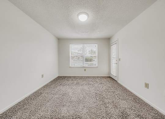 A room with a carpeted floor and a picture on the wall at WaterFront Apartments, Virginia Beach, 23453