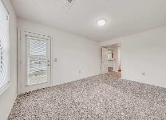 A room with a carpeted floor and a ceiling fan at WaterFront Apartments, Virginia Beach, 23453