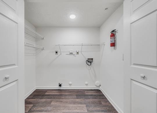 A white closet with a fire extinguisher on the wall at WaterFront Apartments, Virginia Beach, 23453