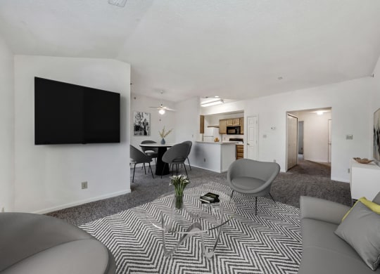 the living room and dining room of an apartment with a couch and chairs at WaterFront Apartments, Virginia
