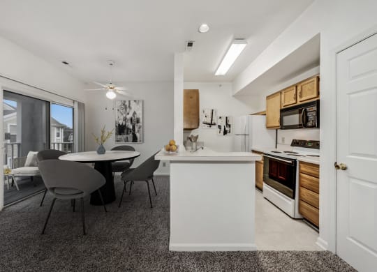 Carpeted dining area with the view of kitchen at WaterFront Apartments, Virginia, 23453