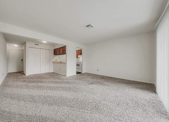 A spacious room with a grey carpet and white walls at WaterFront Apartments, Virginia Beach, 23453