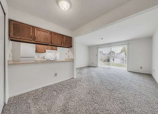 A room with a grey carpet and white walls at WaterFront Apartments, Virginia Beach, 23453