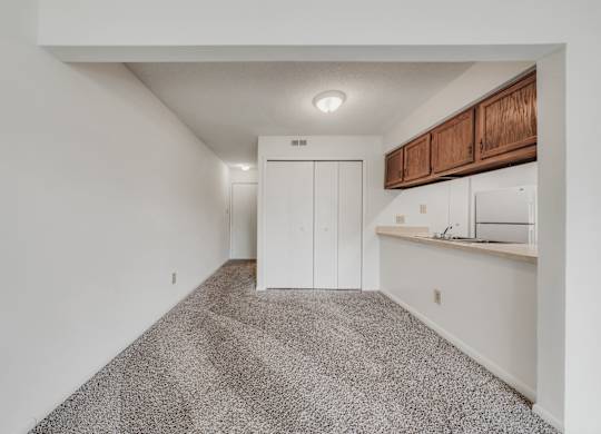 A room with a carpeted floor and a white wall at WaterFront Apartments, Virginia Beach, 23453
