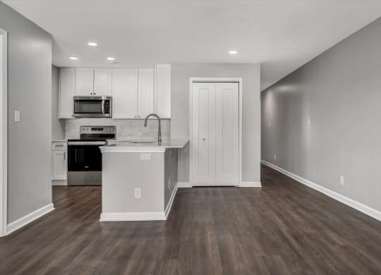 Living room and kitchen with white cabinets and a counter top at WaterFront Apartments, Virginia Beach, VA, 23453