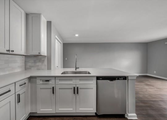 the kitchen of a new home with white cabinets and a sink at WaterFront Apartments, Virginia Beach, 23453