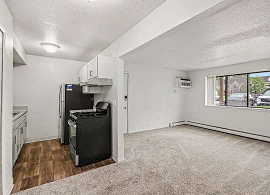 A kitchen with a fridge, stove, and oven.