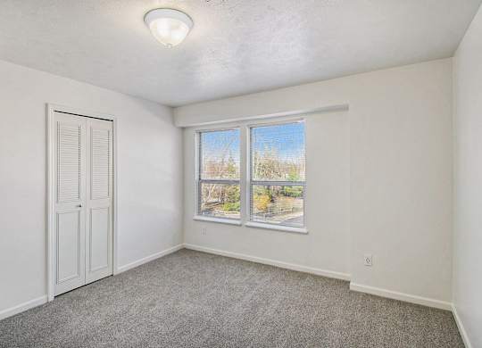 A room with a window and a door at West Hampton Park Apartments in Elkhorn, NE 68022