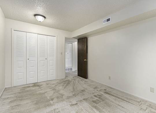 A bedroom with a large closet at West Wind Apartments, Fort Wayne, 46808