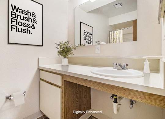 A bathroom with a large vanity at Windmill Lakes Apartments, Holland, Michigan 49424