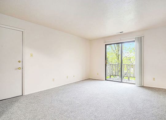 living room with a door to a balcony at Wingate Apartments, Michigan, 49512