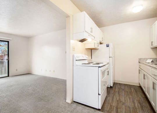 kitchen with white appliances and a window at Wingate Apartments, Kentwood, MI, 49512